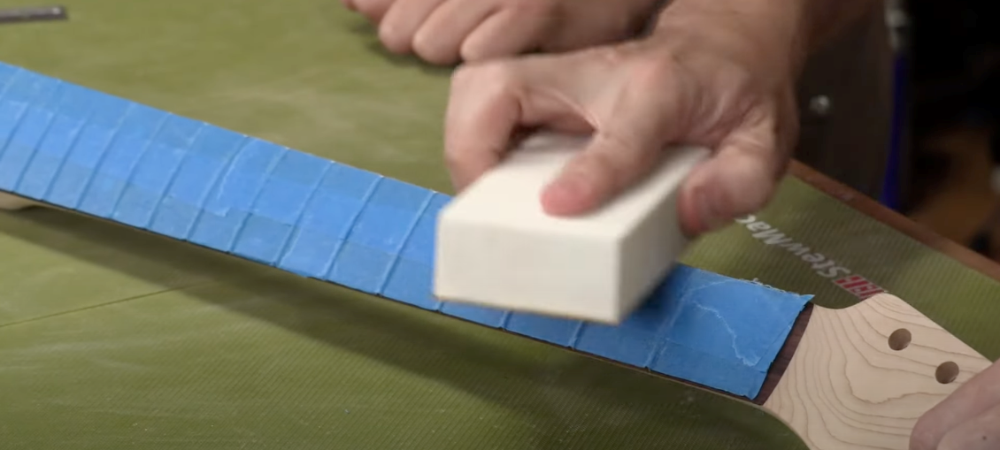 White foam block with 320 grit paper on it